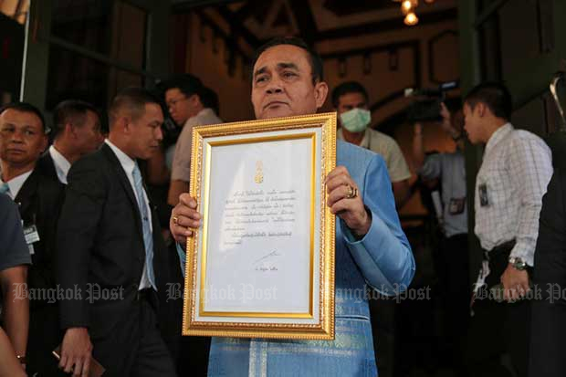 Prime Minister Prayut Chan-o-cha shows the message from His Majesty the King, after it was framed, at Government House on Tuesday. (Photo by Chanat Katanyu)