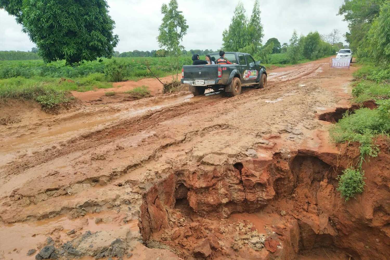 à¹‡Heavy rain washed away this section of road at Phan Charoen village in Chumphuang district of Nakhon Ratchasima province. (Photo by Prasit Tangprasert)