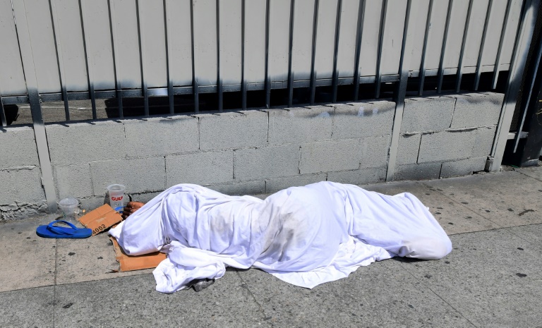 A homeless person' sleeping under a sheet on a sidewalk in Los Angeles on Sunday, home to one of the nation's largest homeless populations. A homeless person' sleeping under a sheet on a sidewalk in Los Angeles on Sunday, home to one of the nation's largest homeless populations.