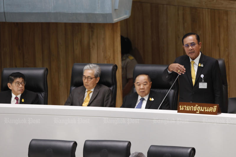 Prime Minister Prayut Chan-o-cha speaks during the general debate centred on his incomplete oath in Parliament on Wednesday. (Photo by Wichan Charoenkiatpakul)