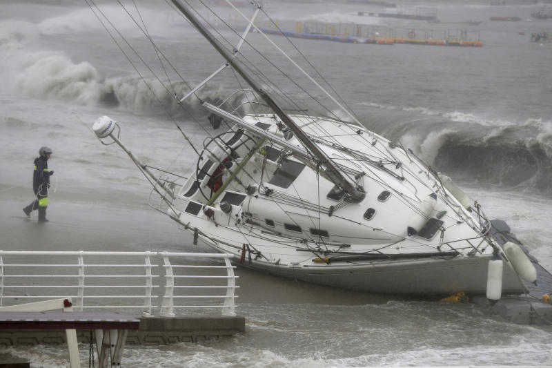 A yacht is pushed ashore by strong winds and high waves at a beach as Typhoon Tapah approaches in Ulsan, South Korea on Sunday. The powerful typhoon has battered southern South Korea after lashing parts of Japan’s southern islands with heavy rains and winds. (AP photo)