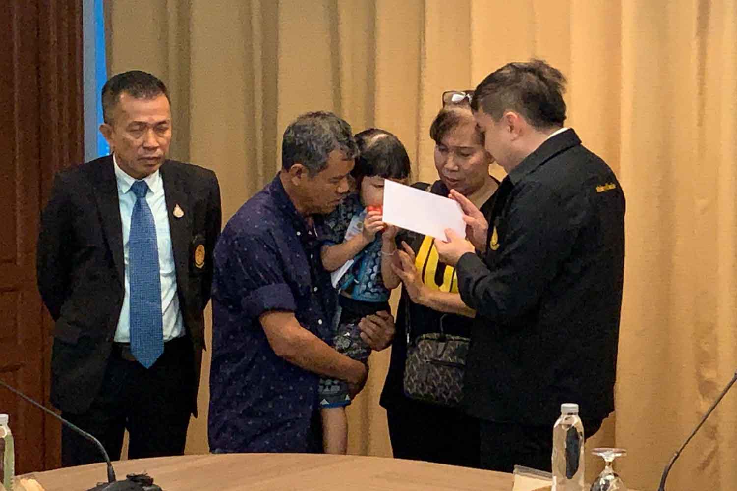 The parents of deceased product presenter Thitima Noraphanpiphat, with her three-year-old child, file their request for a second autopsy at the Justice Ministry in Bangkok on Thursday. (Photo supplied)