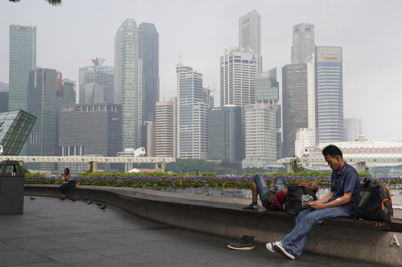 Singaporeans sit next to a pool as the central business district is shrouded by haze in September this year. The haze was among the top five searches on Google in the city-state. (AP photo) Singaporeans sit next to a pool as the central business district is shrouded by haze in September this year. The haze was among the top five searches on Google in the city-state. (AP photo)