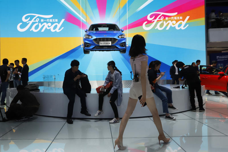 Attendees visit the Ford booth during the Auto China 2018 Show held in Beijing on April 25, 2018. China’s government says it will postpone planned punitive tariffs on US-made automobiles and other goods. (AP photo) Attendees visit the Ford booth during the Auto China 2018 Show held in Beijing on April 25, 2018. China’s government says it will postpone planned punitive tariffs on US-made automobiles and other goods. (AP photo)