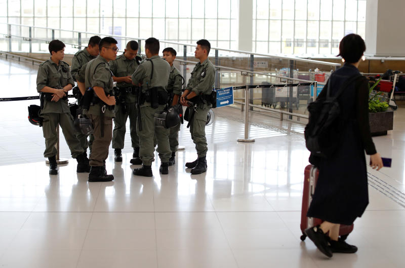 Passenger walks past riot police standing inside Hong Kong International Airport in Hong Kong on Sept 22, 2019. (Reuters photo) Passenger walks past riot police standing inside Hong Kong International Airport in Hong Kong on Sept 22, 2019. (Reuters photo)