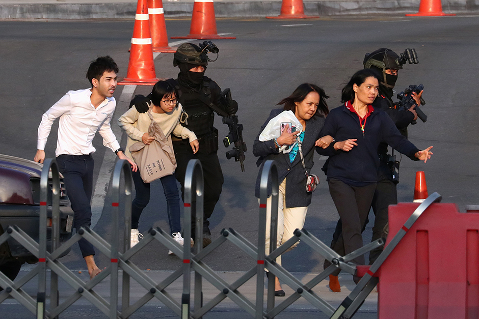 More people stranded inside Terminal 21 are evacuated on Sunday. — Reuters
