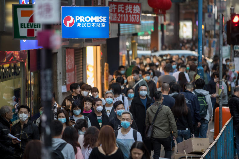People wearing masks walk on a street in Kwun Tong district of Hong Kong on Thursday. (Bloomberg photo) People wearing masks walk on a street in Kwun Tong district of Hong Kong on Thursday. (Bloomberg photo)