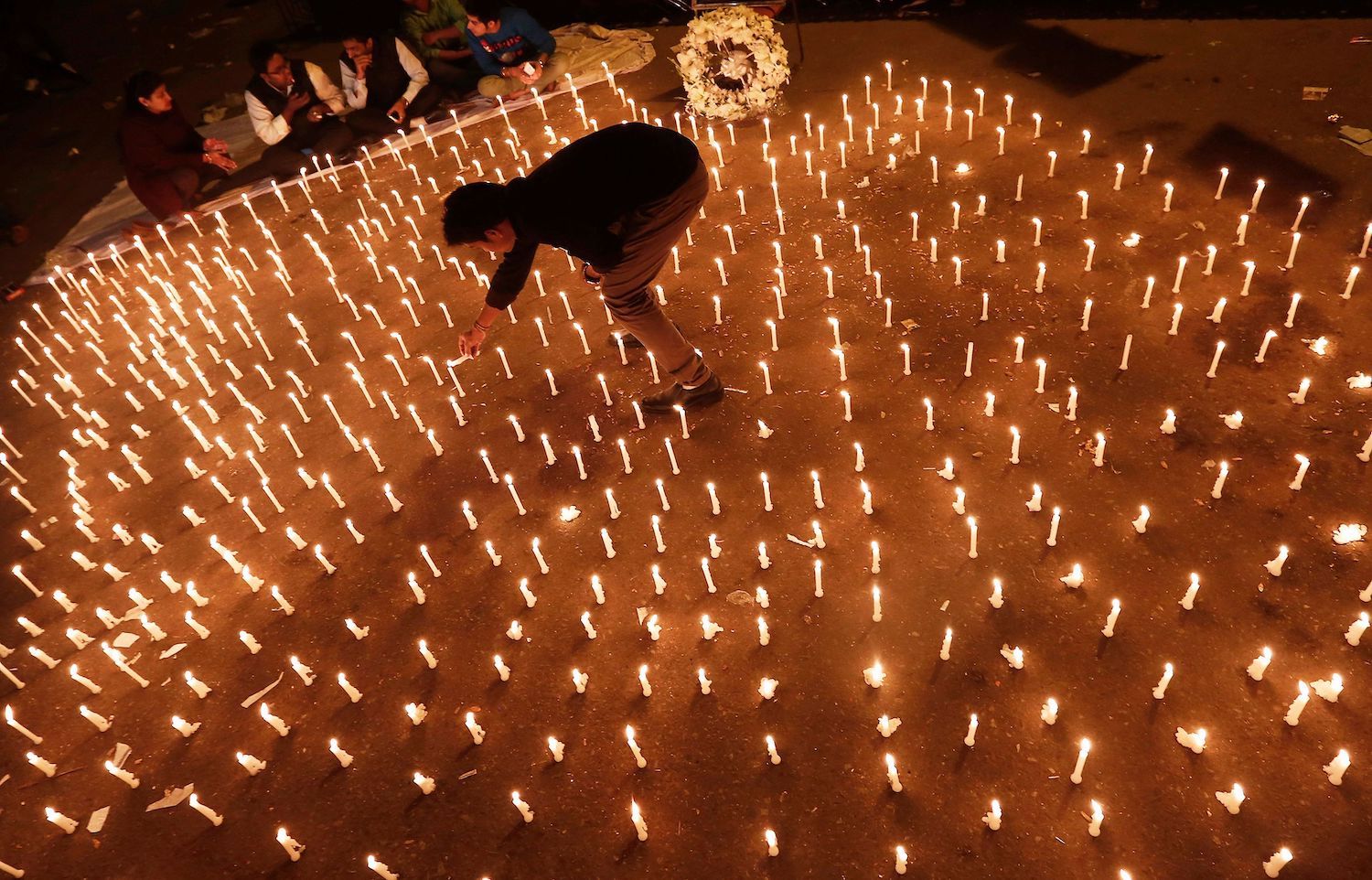 A participant lights candles during a vigil held to mark the first anniversary of the Delhi gang rape, in New Delhi on Dec 16, 2013. (Reuters Photo) A participant lights candles during a vigil held to mark the first anniversary of the Delhi gang rape, in New Delhi on Dec 16, 2013. (Reuters Photo)