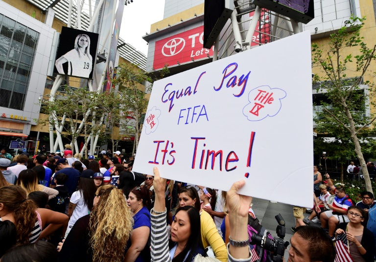 A US women's soccer fan displays a sign calling for equal pay at a rally to celebrate last year's US title run at the Women's World Cup. A US women's soccer fan displays a sign calling for equal pay at a rally to celebrate last year's US title run at the Women's World Cup.