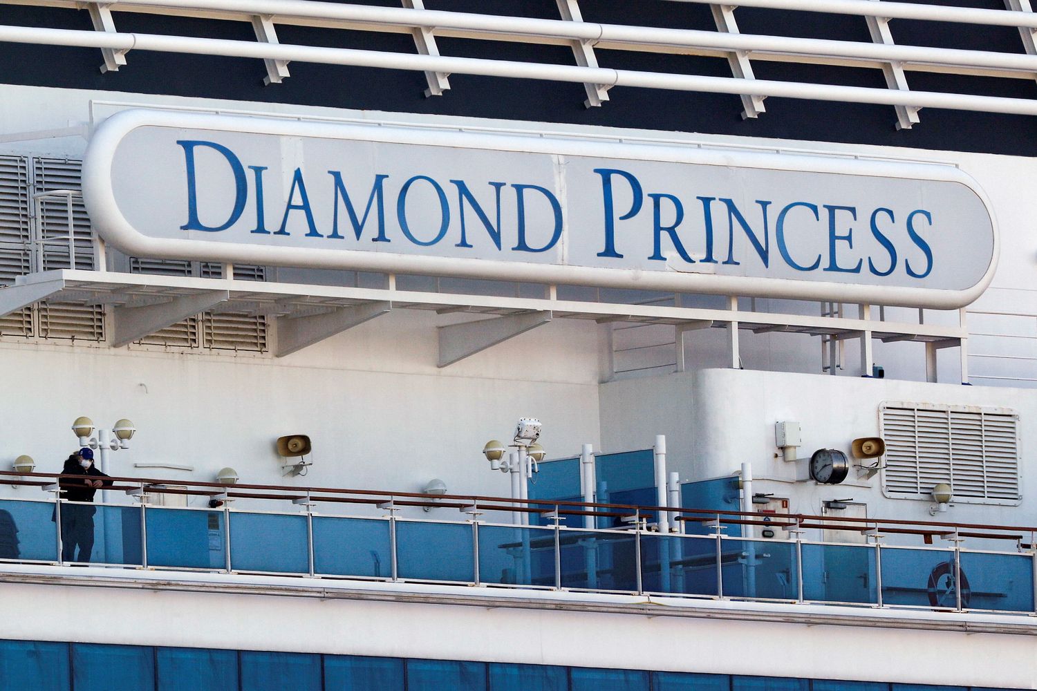 A passenger wearing a mask stands on the deck of the cruise ship 'Diamond Princess', as the vessel's passengers continue to be tested for coronavirus, at Daikoku Pier Cruise Terminal in Yokohama, south of Tokyo, on Thursday. (Reuters photo) A passenger wearing a mask stands on the deck of the cruise ship 'Diamond Princess', as the vessel's passengers continue to be tested for coronavirus, at Daikoku Pier Cruise Terminal in Yokohama, south of Tokyo, on Thursday. (Reuters photo)