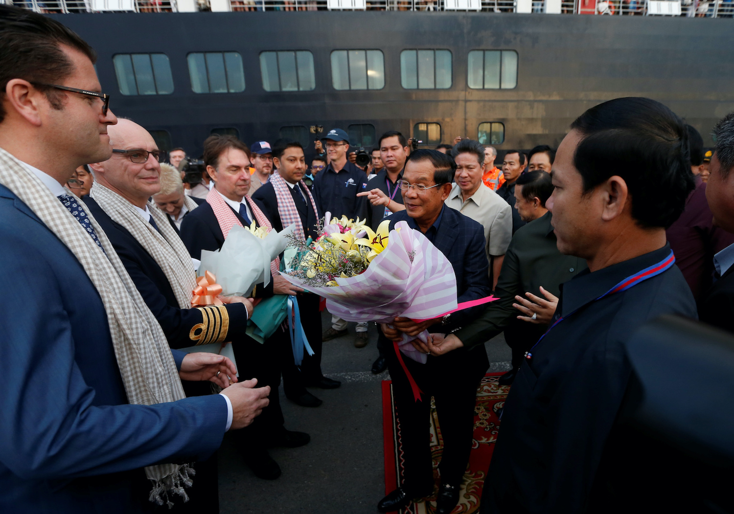 Prime Minister Hun Sen offers flowers as he welcomes the passengers and crew of MS Westerdam in Sihanoukville on Friday. (Reuters Photo) Prime Minister Hun Sen offers flowers as he welcomes the passengers and crew of MS Westerdam in Sihanoukville on Friday. (Reuters Photo)