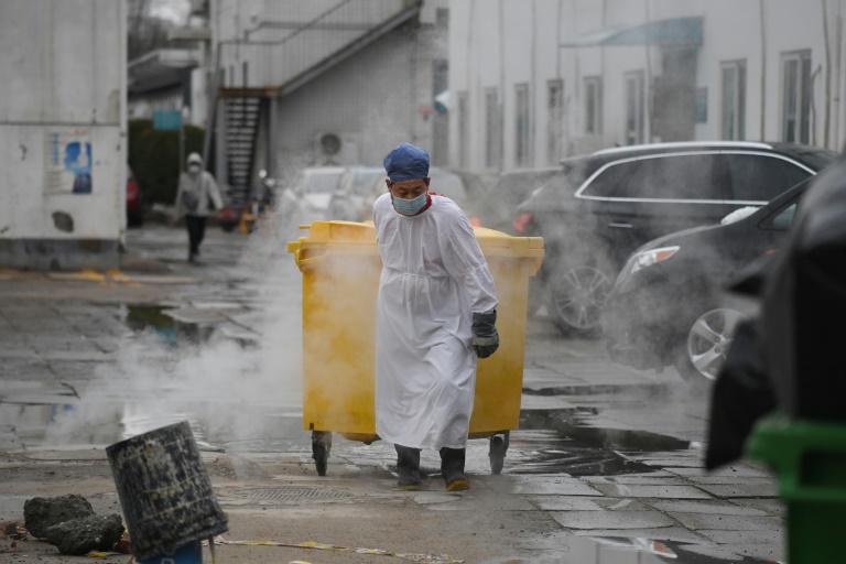 A worker moves medical waste at a hospital in Beijing treating coronavirus patients. (AFP photo) A worker moves medical waste at a hospital in Beijing treating coronavirus patients. (AFP photo)