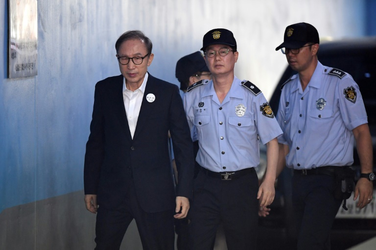 Former South Korean president Lee Myung-bak arriving at court to attend his original trial in 2018. Former South Korean president Lee Myung-bak arriving at court to attend his original trial in 2018.