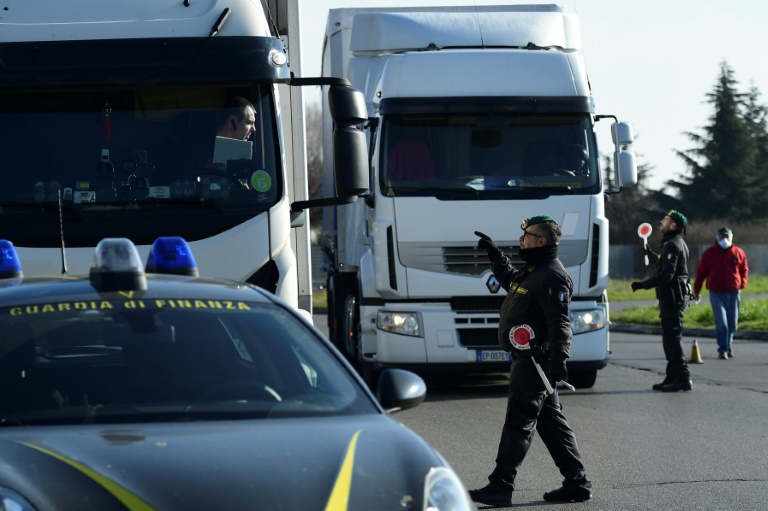 Italian police at the entrance to the small town of Casalpusterlengo, southeast of Milan, as authorities try to halt the spread of the coronavirus which claimed a fourth victim in Italy on Monday. Italian police at the entrance to the small town of Casalpusterlengo, southeast of Milan, as authorities try to halt the spread of the coronavirus which claimed a fourth victim in Italy on Monday.
