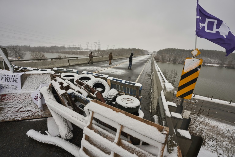 First Nations protestors walk on a bridge past their barricade on Highway 6 near Caledonia, Ontario which the protestors set up in support of the Wet'suwet'en hereditary chiefs and the Tyendinaga Mohawks on February 26, 2020 First Nations protestors walk on a bridge past their barricade on Highway 6 near Caledonia, Ontario which the protestors set up in support of the Wet'suwet'en hereditary chiefs and the Tyendinaga Mohawks on February 26, 2020