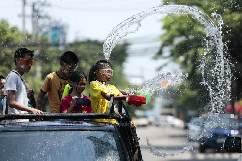 Children take part in a water war during the Songkran festival in Soi Sukhumvit 101 on April 14, 2018. The government plans to postpone the holiday this year to control the spread of the new coronavirus. (Photo by Patipat Janthong)