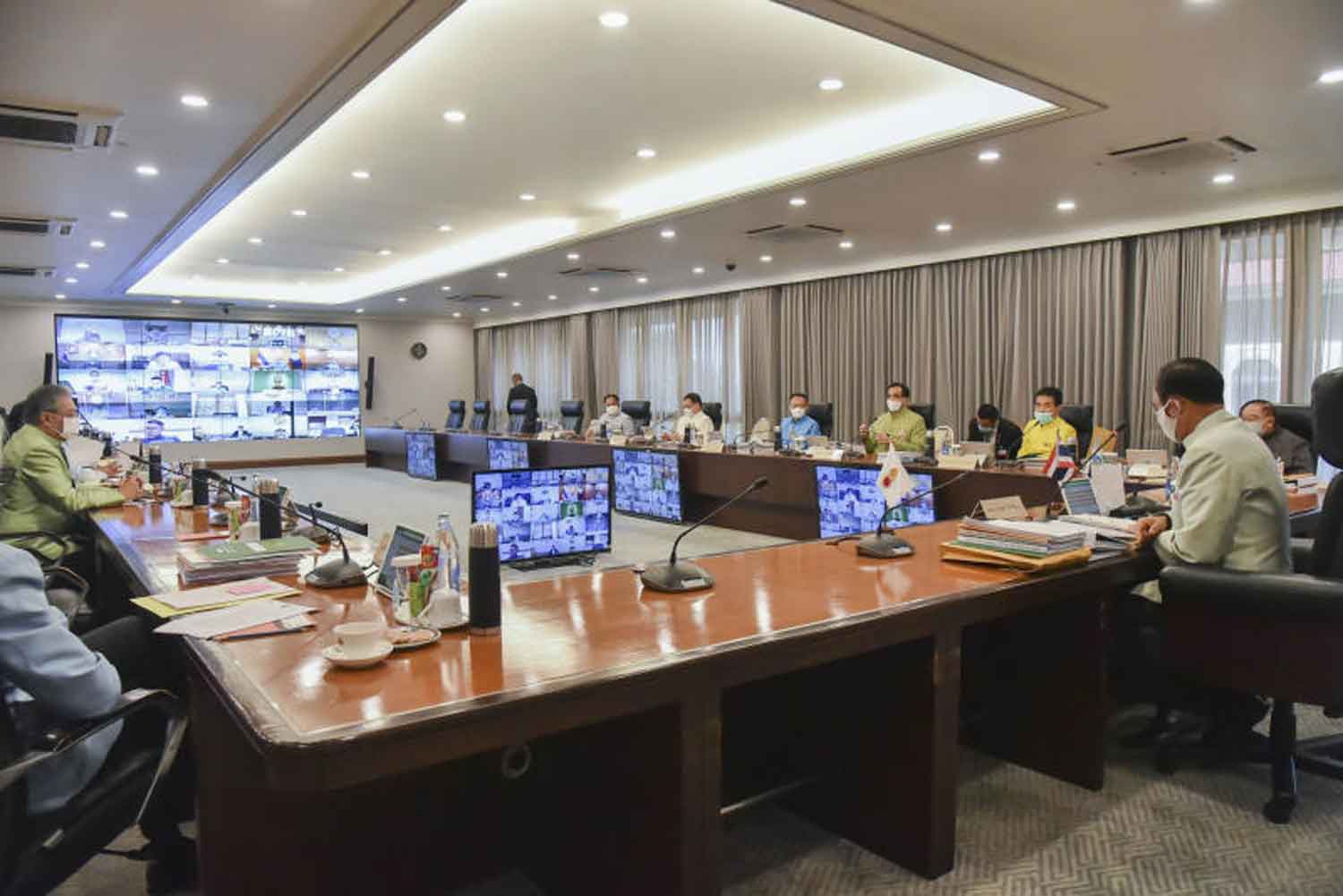 The cabinet holds its first weekly teleconference at Government House in Bangkok on Tuesday, with some ministers practising social distancing and others calling in from their ministries. (Government House photo)