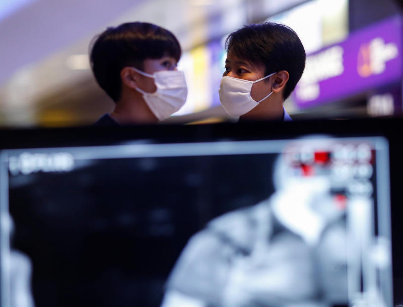 Passengers wear protective face masks due to the coronavirus disease outbreak at  Suvarnabhumi airport on Friday. (Reuters photo)