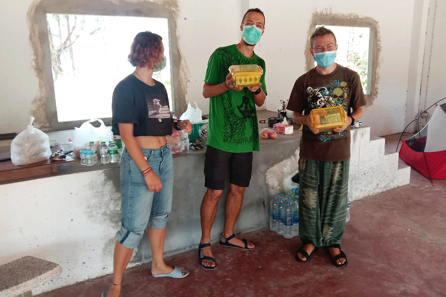 Three Russian tourists have been cooking donated food in a building next to the crematorium at Wat Mai Khao near the Phuket airport after running out of money. (Photo by Achadtaya Chuenniran)