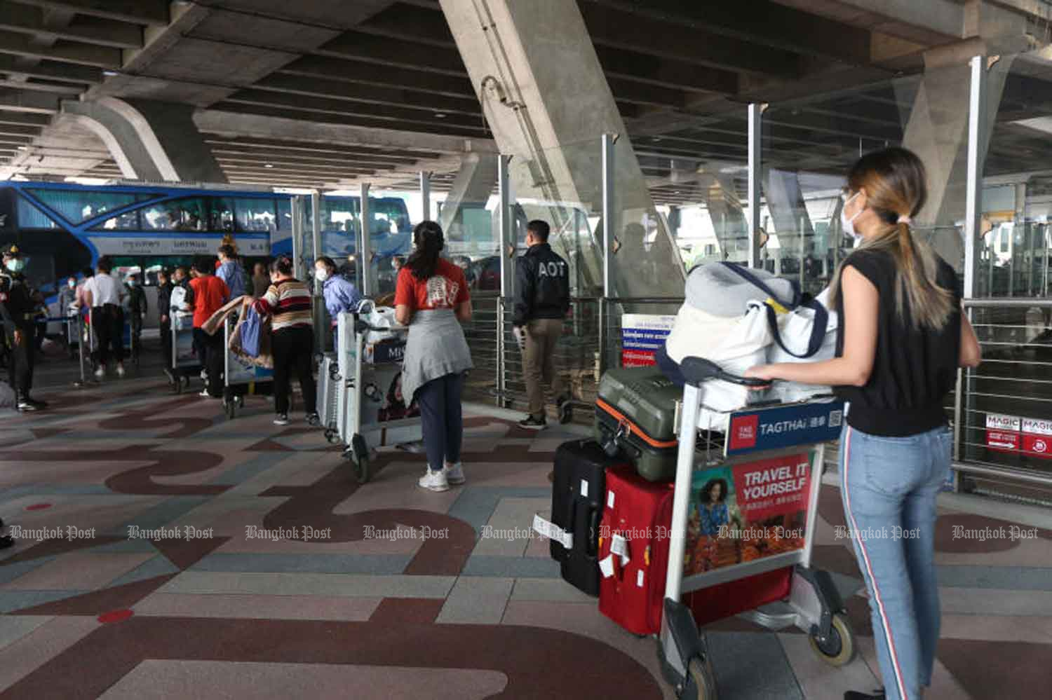 Thais arrive back from Japan, at Suvarnabhumi airport in Samut Prakan province on Wednesday. Sick people were sent to hospital and the other returnees taken to a converted  hotel-quarantine facility in Bangkok. (Photo: Varuth Hirunyatheb)