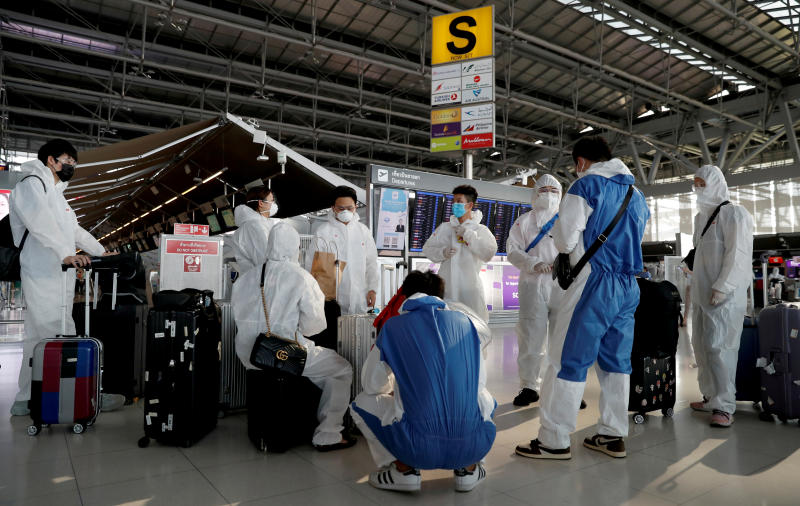 Chinese students living in Thailand wear protective suits as a measure of protection against the coronavirus disease at Suvarnabhumi Airport before boarding a repatriation flight on Tuesday. (Reuters photo) Chinese students living in Thailand wear protective suits as a measure of protection against the coronavirus disease at Suvarnabhumi Airport before boarding a repatriation flight on Tuesday. (Reuters photo)