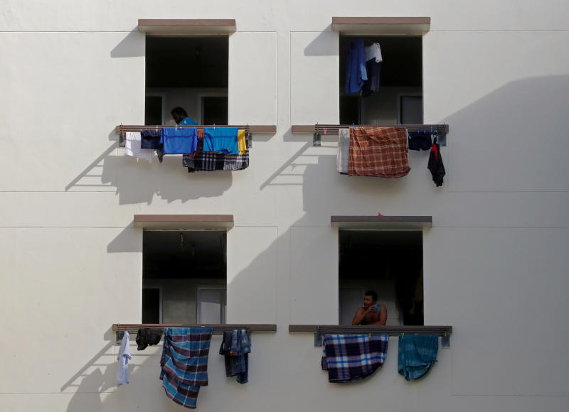 Migrant workers look out of windows in a dormitory, amid the coronavirus disease outbreak in Singapore May 15, 2020. (Reuters file photo) Migrant workers look out of windows in a dormitory, amid the coronavirus disease outbreak in Singapore May 15, 2020. (Reuters file photo)