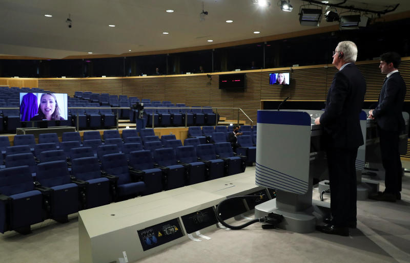 EU's Brexit negotiator Michel Barnier speaks with a journalist displayed on a screen during a news conference after Brexit negotiations in Brussels on Friday. (Reuters photo)