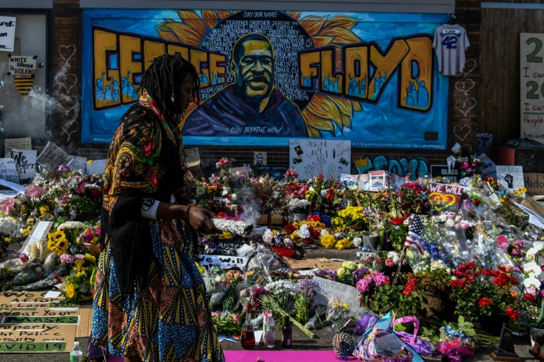 A woman burns sage and offers prayers as she pays her respects at a makeshift memorial in honor of George Floyd, who died while in police custody on May 25 A woman burns sage and offers prayers as she pays her respects at a makeshift memorial in honor of George Floyd, who died while in police custody on May 25