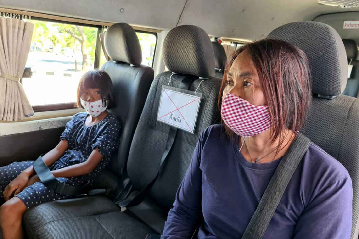 Interprovincial travellers are forced to comply with social distancing in a passenger van in Nakhon Ratchasima province on Wednesday. (Photo: Prasit Tangprasert)