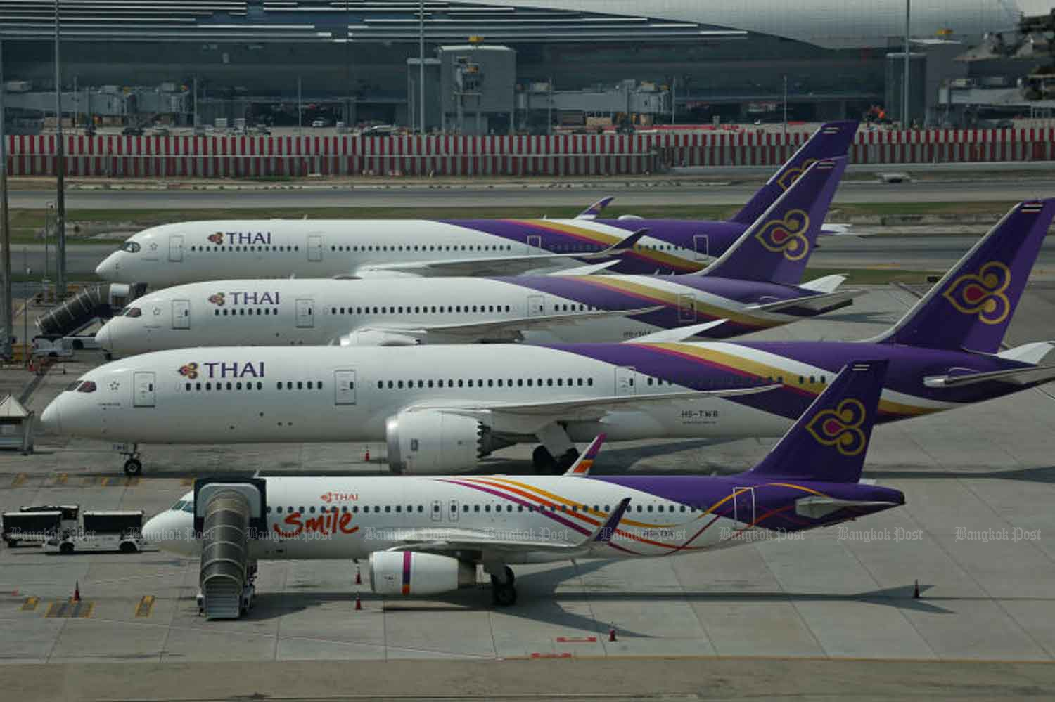 Thai Airways International and THAI Smile planes are grounded on the tarmac at Suvarnabhumi airport. (Bangkok Post photo)