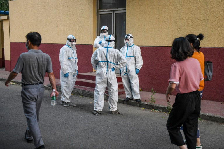 Medical workers in protective equipment take a break at a testing centre for COVID-19 in Beijing this week after a new outbreak whch is also casting fresh doubts over the suspended Chinese Super League football season Medical workers in protective equipment take a break at a testing centre for COVID-19 in Beijing this week after a new outbreak whch is also casting fresh doubts over the suspended Chinese Super League football season