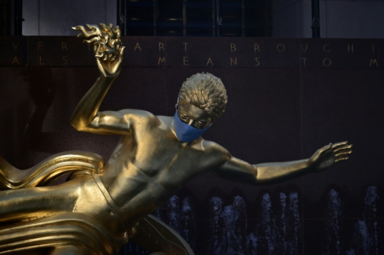 The sculpture of Prometheus adorned with a face mask is pictured at Rockefeller Center in Manhattan on June 24 in New York City. The sculpture of Prometheus adorned with a face mask is pictured at Rockefeller Center in Manhattan on June 24 in New York City.