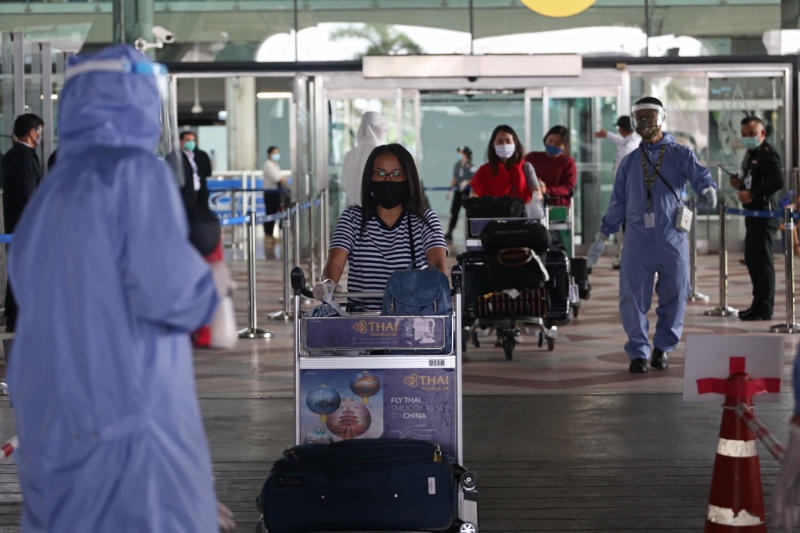 People arrive at Suvarnabhumi airport following a repatriation flight from the United Kingdom on June 14. (Bangkok Post file photo)