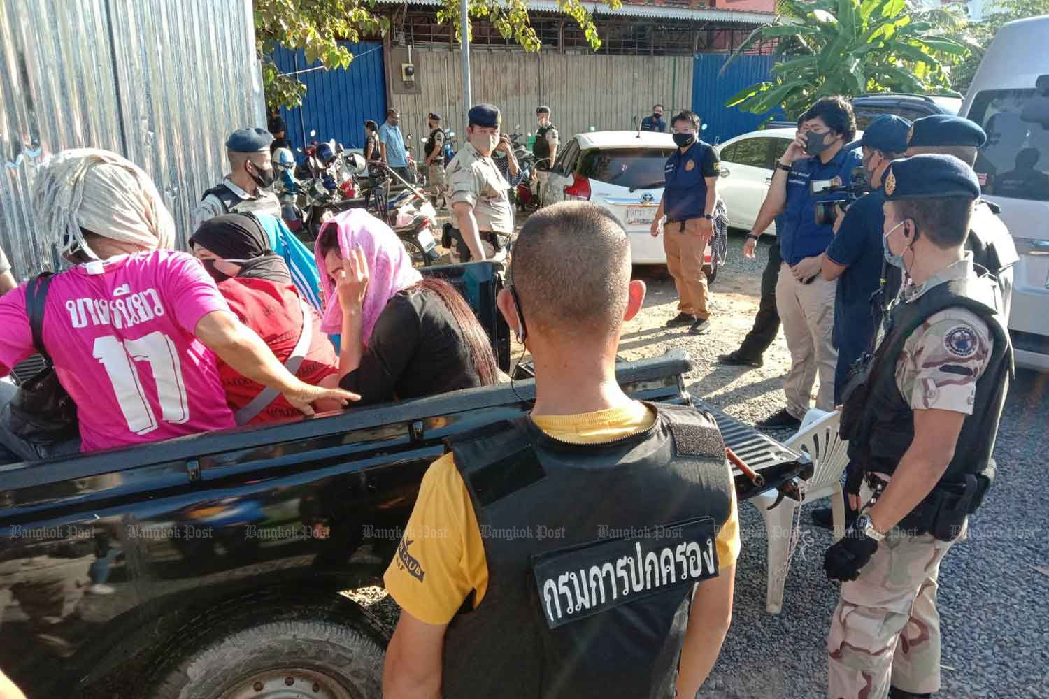 Some of the gamblers arrested at a casino operating in Muang district of Phuket are loaded on a pickup before being taken to a police station on Tuesday. (Photo: Achadtaya Chuenniran)