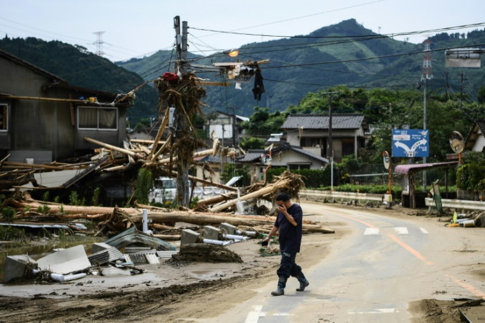 Japan rescuers battle to reach thousands trapped by floods