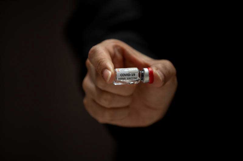 A researcher holds up an mRNA type vaccine candidate for the coronavirus disease during a news conference at the National Primate Research Center of Chulalongkorn University in Saraburi province on June 22, 2020. (Reuters photo)