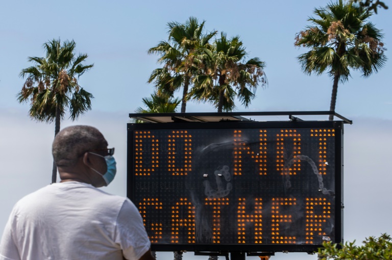 In the middle of summer vacation season, a sign urges people not to gather in Long Beach, California. In the middle of summer vacation season, a sign urges people not to gather in Long Beach, California.