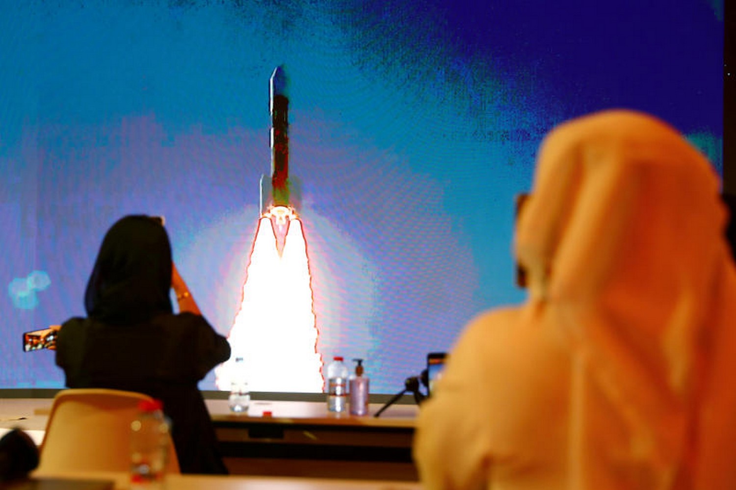 People watch a big screen displaying the launch of the Hope Probe from Tanegashima Island in Japan, at the Mohammed bin Rashid Space Centre in Dubai, United Arab Emirates on July 20. (Photo: Reuters) People watch a big screen displaying the launch of the Hope Probe from Tanegashima Island in Japan, at the Mohammed bin Rashid Space Centre in Dubai, United Arab Emirates on July 20. (Photo: Reuters)