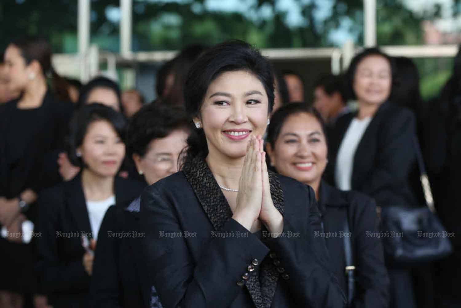 Former prime minister Yingluck Shinawatra greets supporters outside the Supreme Court's Criminal Division for Holders of Political Positions in Bangkok in 2017. (Bangkok Post file photo)