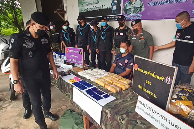 Niphon Chuenchom (centre) sits with 72,000 methamphetamine pills during a press briefing after he was arrested in Tha Uthen district of Nakhon Phanom on Saturday. (Photo by Pattanapong Sripiachai) Niphon Chuenchom (centre) sits with 72,000 methamphetamine pills during a press briefing after he was arrested in Tha Uthen district of Nakhon Phanom on Saturday. (Photo by Pattanapong Sripiachai)