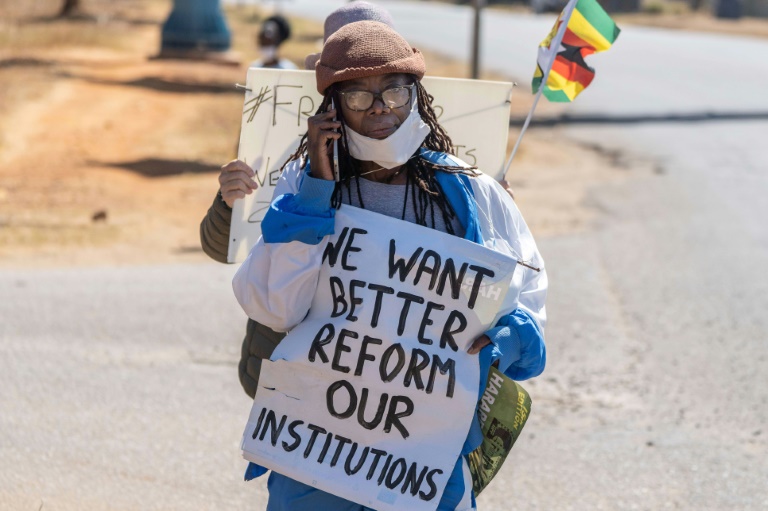 Zimbabwean novelist Tsitsi Dangarembga holds a placard during an anti-corruption march along Borrowdale road, in Harare; she was arrested and freed on bail the following day Zimbabwean novelist Tsitsi Dangarembga holds a placard during an anti-corruption march along Borrowdale road, in Harare; she was arrested and freed on bail the following day