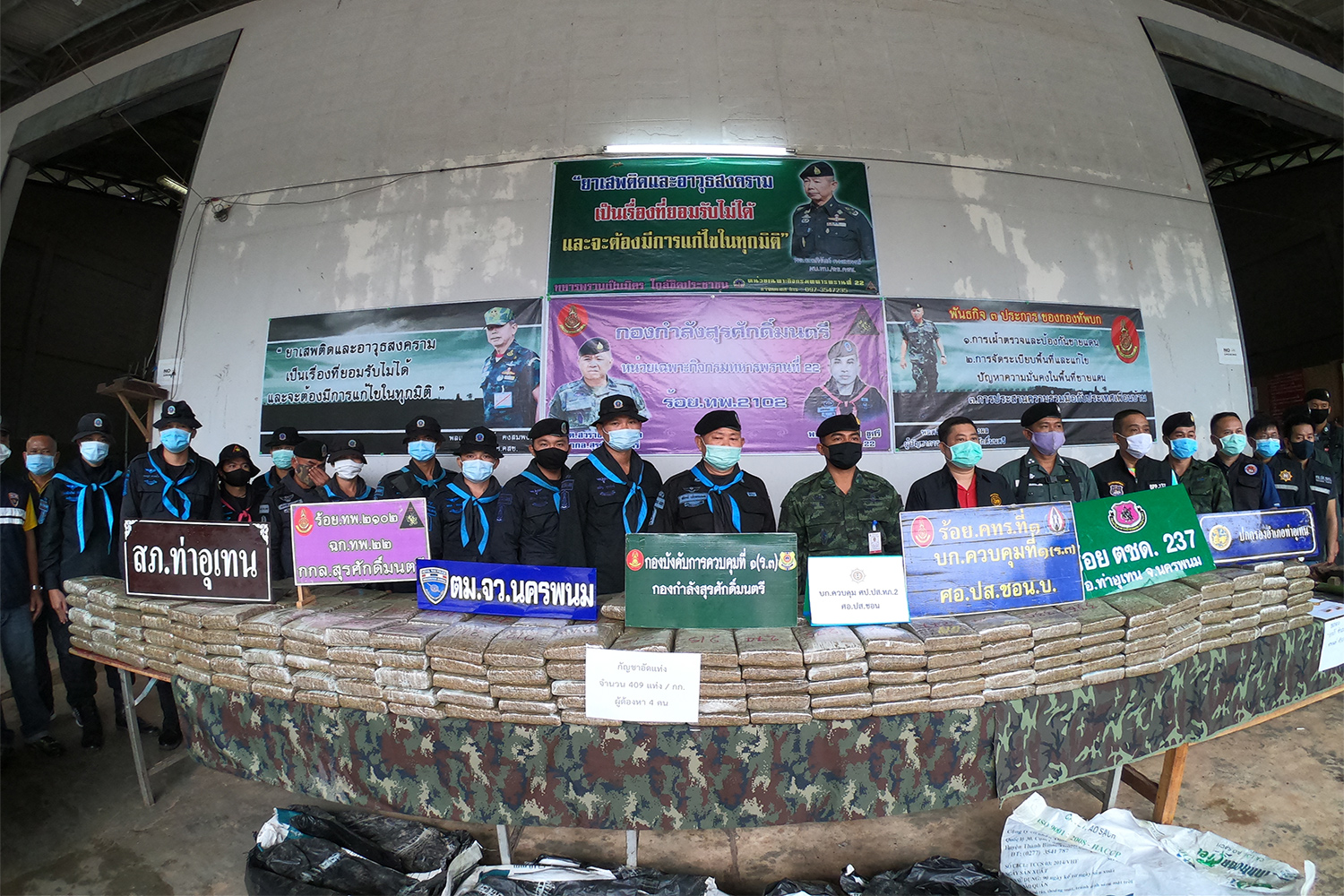 Security authorities display more than 400 kilogrammes of comprssed marijuana seized in Tha Uthen district of Nakhon Phanom on Saturday night. (Photo by Pattanapong Sripiachai)