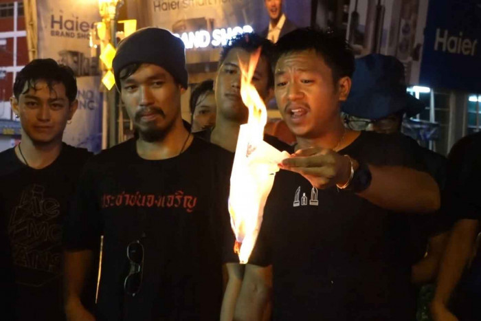 Activist 'Pai Dao Din' burns police summons at Khon Kaen rally