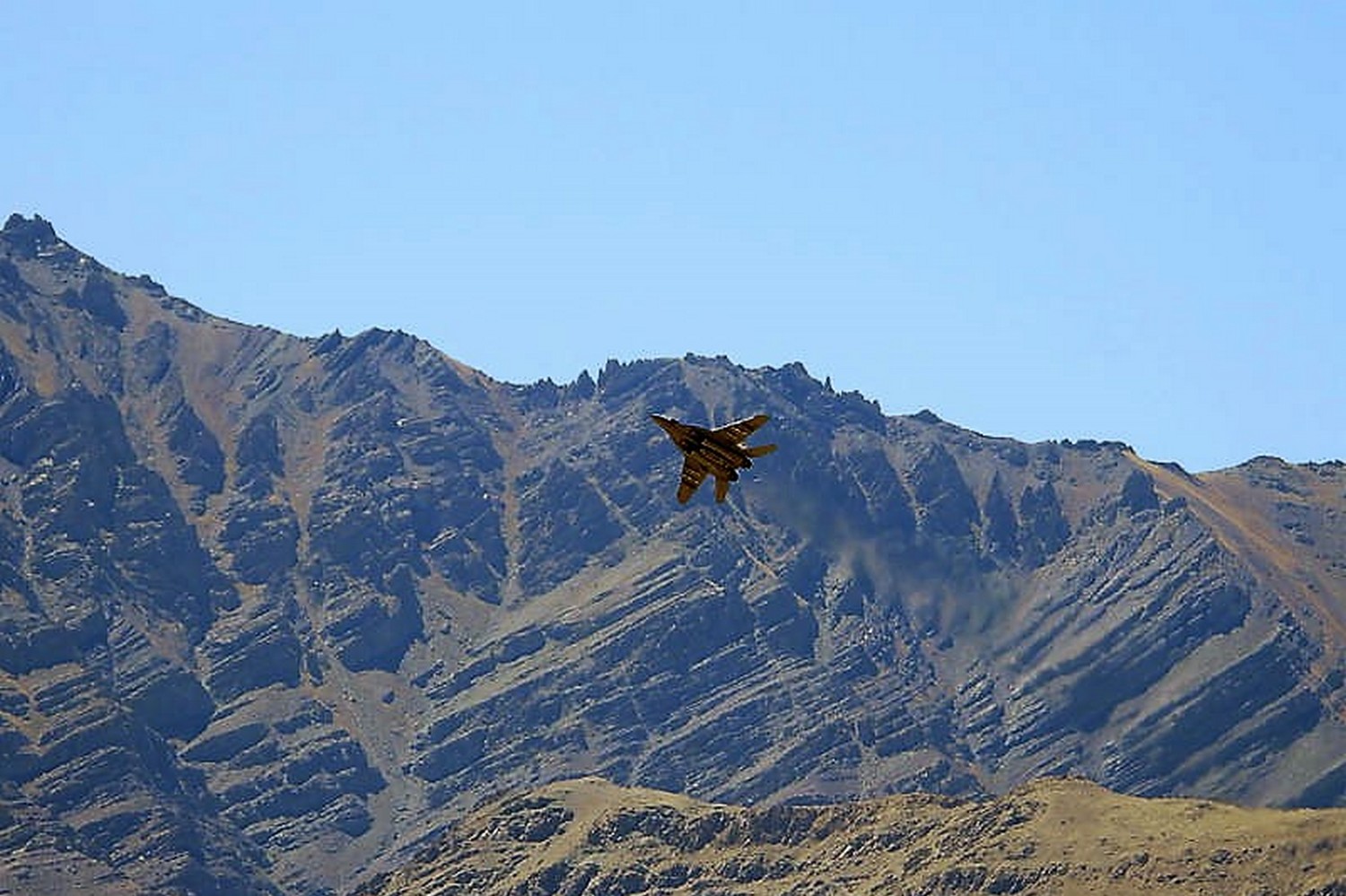 An Indian fighter plane flies over a mountain range in Leh, in the Ladakh border region with China, on Wednesday this week. (Photo: Reuters)