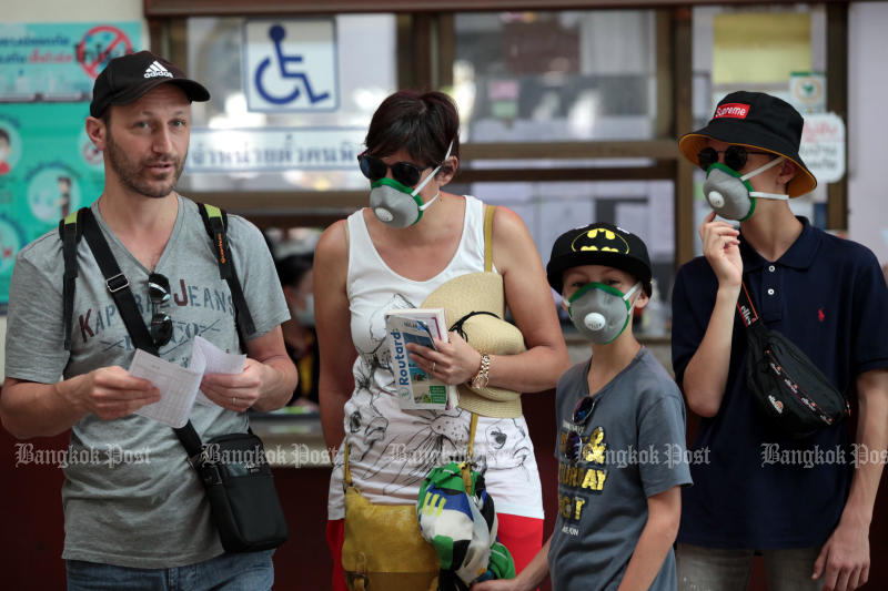 Tourists wearing face masks are seen at Hua Lamphong station on March 5, 2020. (Photo: Chanat Katanyu)