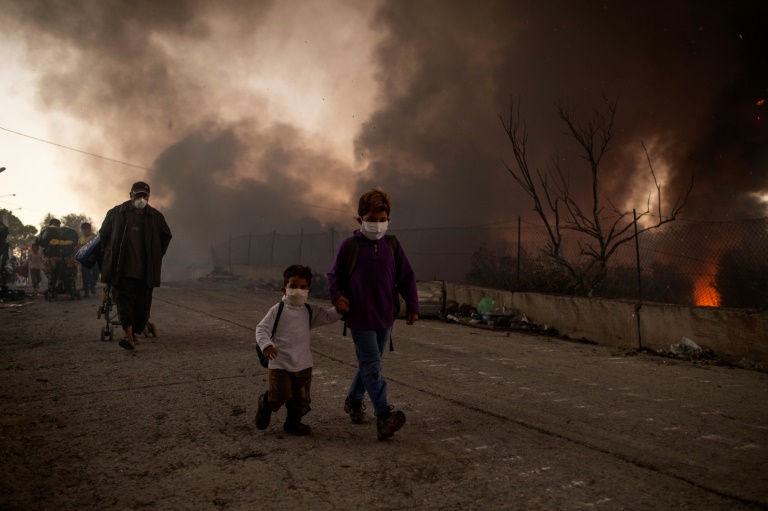 The outbreak of fire at Moria camp, Greece's largest and most notorious migrant facility, sent thousands fleeing for safety into nearby olive groves The outbreak of fire at Moria camp, Greece's largest and most notorious migrant facility, sent thousands fleeing for safety into nearby olive groves