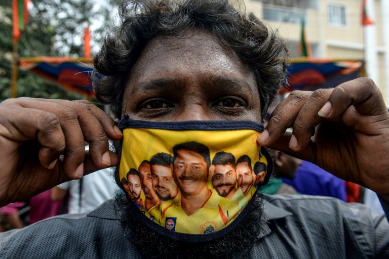 This fan in Chennai has a facemask decorated with pictures of Chennai Super Kings players This fan in Chennai has a facemask decorated with pictures of Chennai Super Kings players