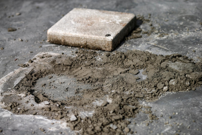 A close-up view of the spot where a plaque placed by Thai pro-democracy protesters near the Grand Palace in Bangkok that declared that Thailand belongs to the people and not the king, is seen after the plaque was removed, in Bangkok, on Monday. (Reuters photo)