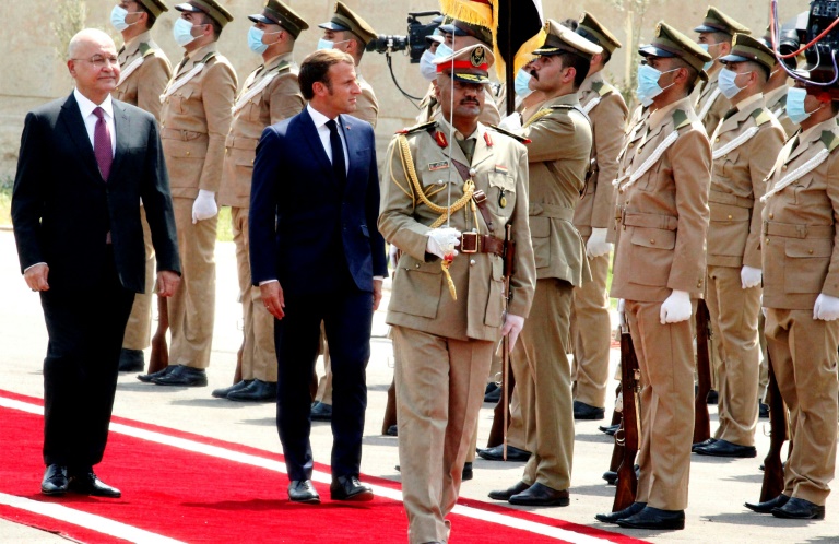 Iraq's President Barham Saleh, who is warning of risks to his country, inspects an honor guard as he welcomes French President Emmanuel Macron (left) on September 2, 2020 Iraq's President Barham Saleh, who is warning of risks to his country, inspects an honor guard as he welcomes French President Emmanuel Macron (left) on September 2, 2020