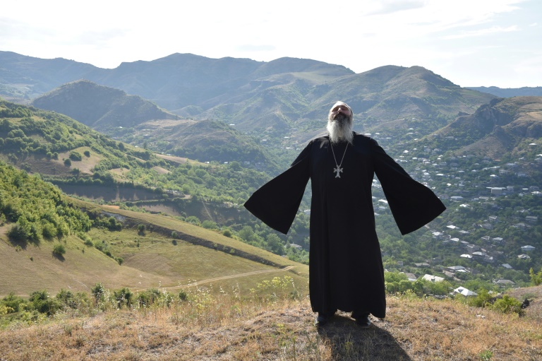 Priest Ter Abel prays for peace outside the village of Movses on the Armenian-Azerbaijani border on July 15, 2020. Priest Ter Abel prays for peace outside the village of Movses on the Armenian-Azerbaijani border on July 15, 2020.